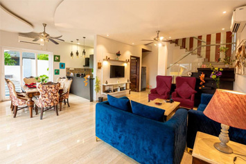 Spacious living hall with sofa and TV at Infinity Villa