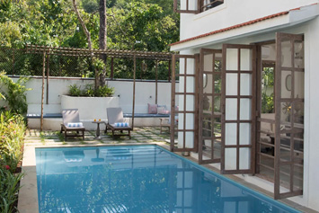 Pool and lounge chair at Igreha Villa