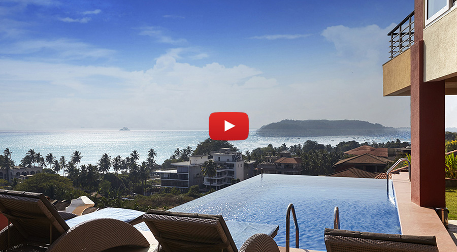 An infinity pool offering stunning ocean views with relaxing poolside seating and a scenic coastal backdrop