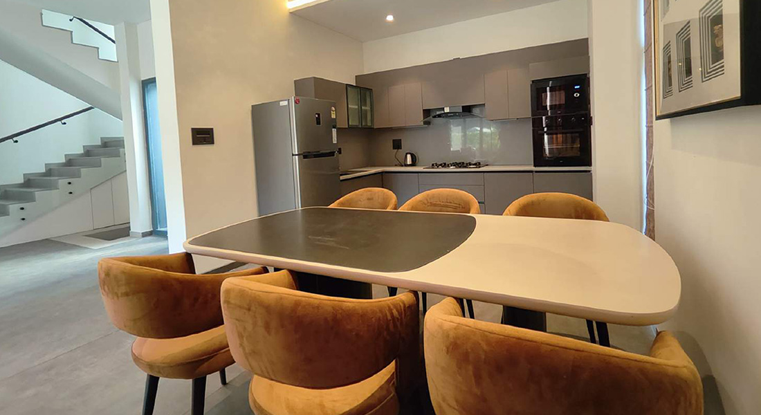 Modern dining and kitchen area in a Goa family villa