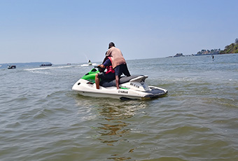 Couple enjoying a jet ski ride at sea