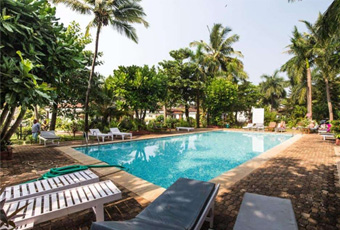 Tropical outdoor swimming pool with lounge chairs