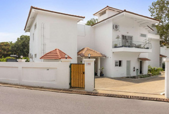 White villa exterior with gated entrance