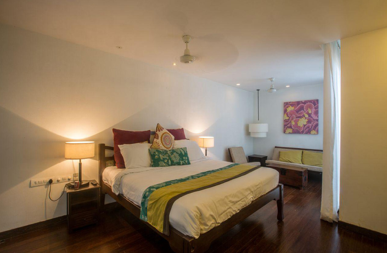 Comfortable bedroom featuring king bed and cozy seating nook