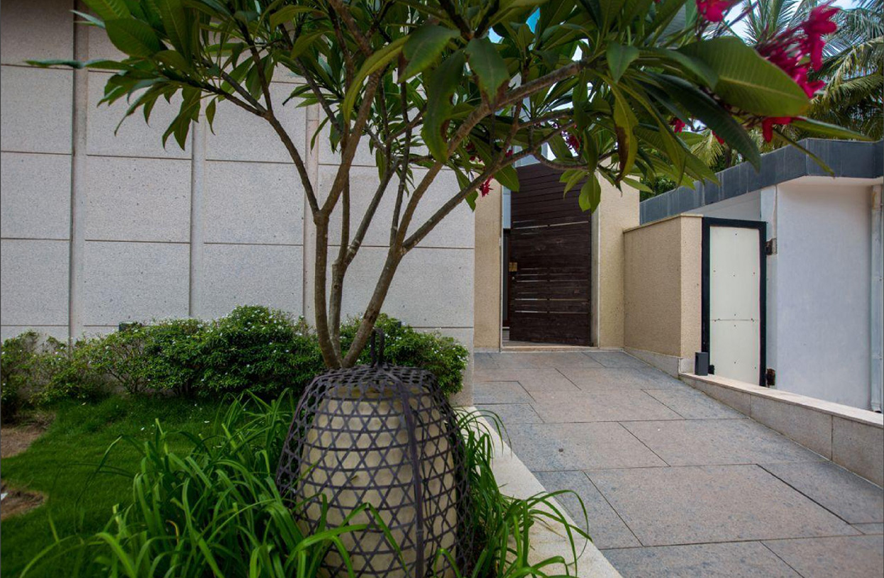 Beautiful garden entrance with greenery and stone pathway