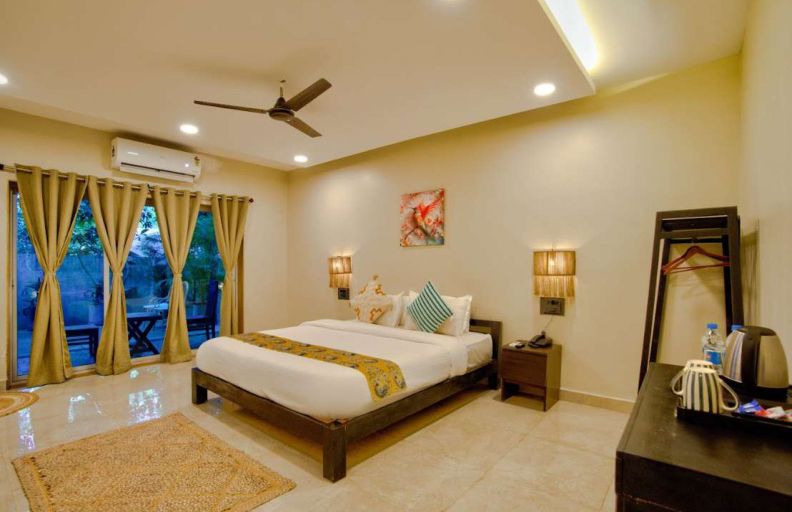 Bedroom with balcony doors and garden view seating