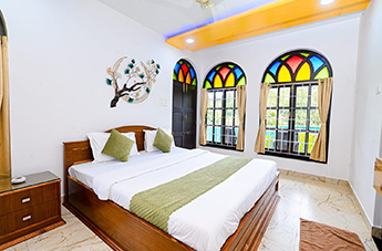 Bright bedroom with large arched windows, natural light and elegant interiors