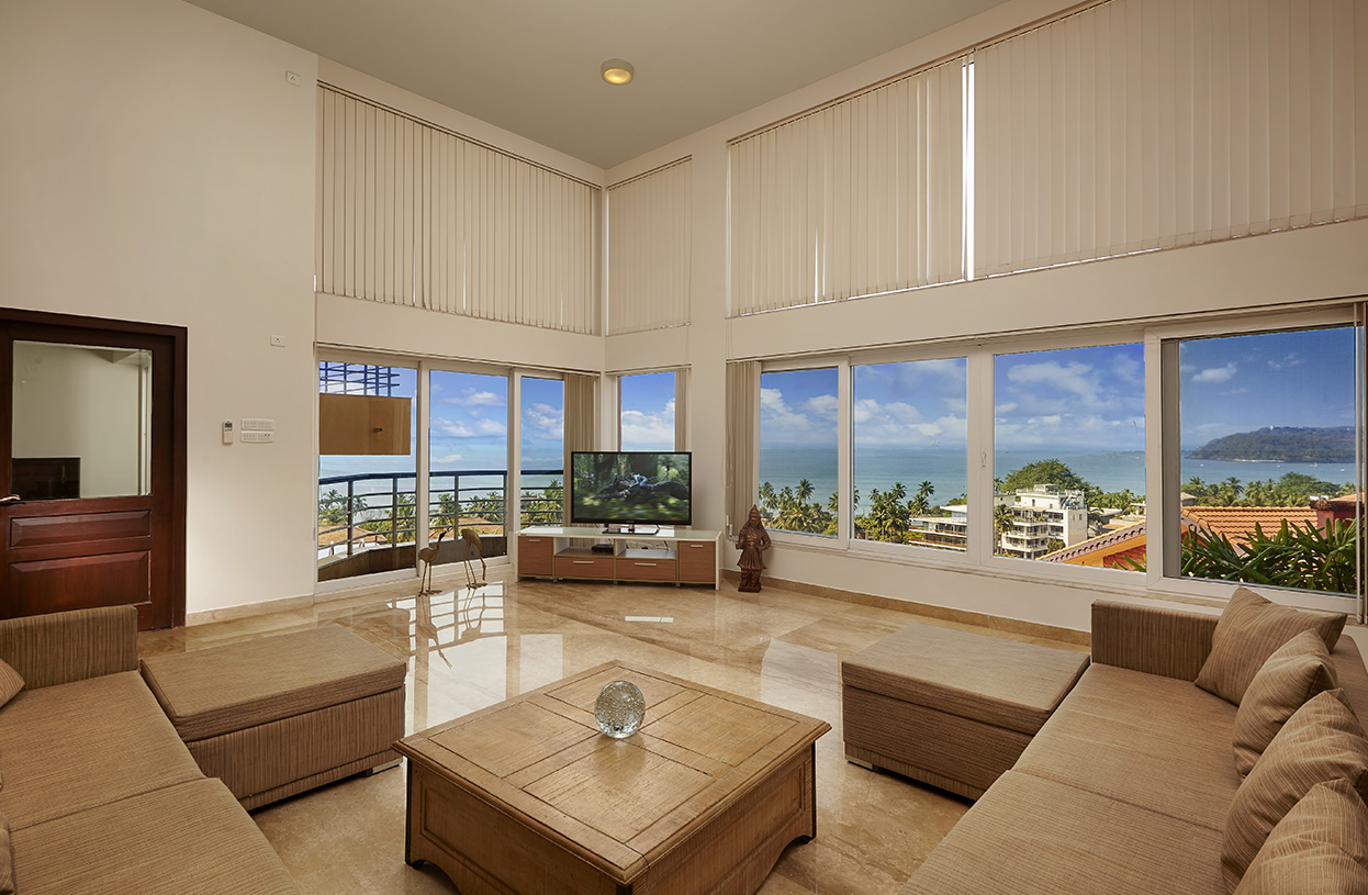 Bright and spacious living hall with floor-to-ceiling windows offering stunning sea views at Dolphin Heights