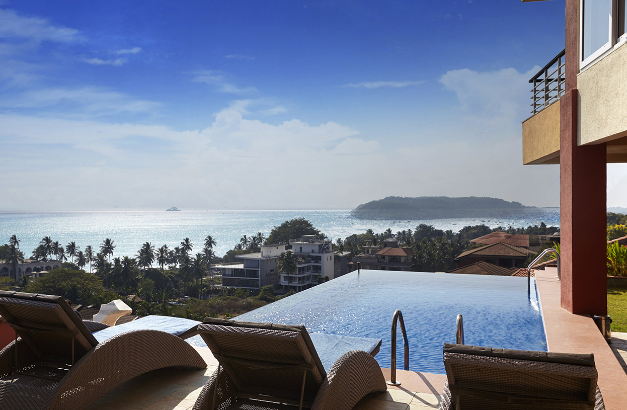 Infinity pool overlooking the ocean with sun loungers and tropical views at Dolphin Heights luxury villa