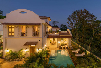 Nighttime exterior view with pool at Colina Villa