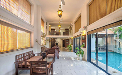 Villa interior with wooden seating, glass doors and swimming pool