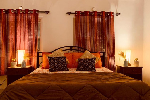 Warm bedroom in a villa with soft lighting and decorative pillows