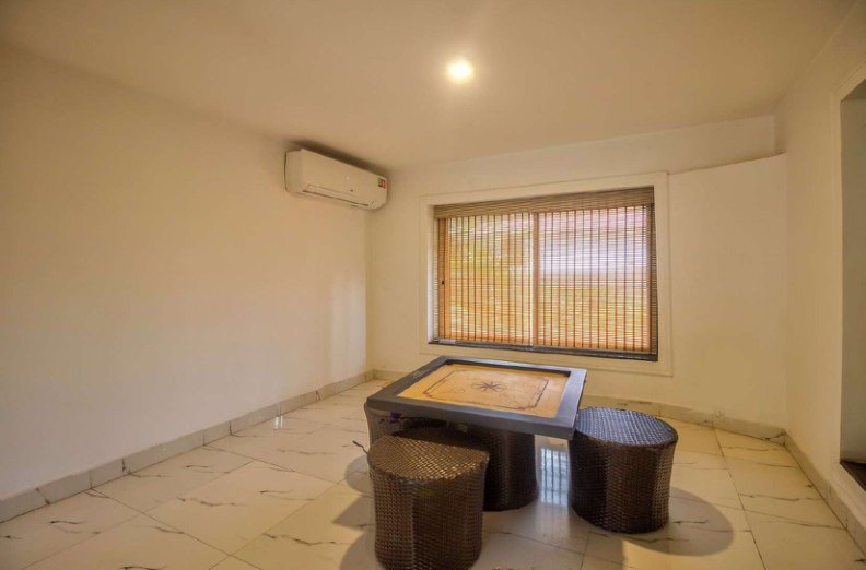 Indoor seating area with wicker table and stools