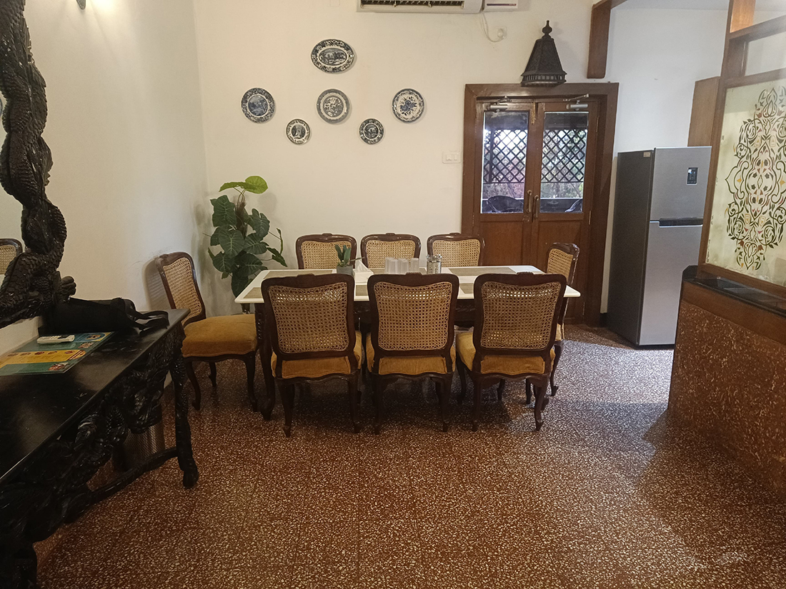 Dining space showing a table, chairs, and wall plates.