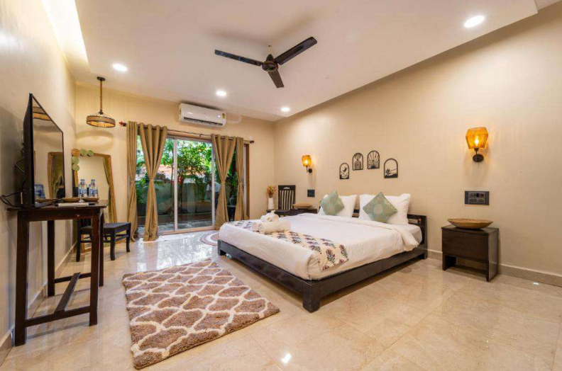 Spacious luxury bedroom with balcony doors and garden view
