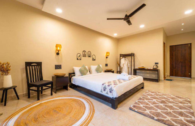 Spacious luxury bedroom with king bed and modern interior in Goa villa