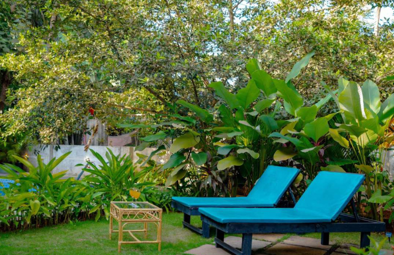 Garden lounge chairs relaxing area in Morjim luxury pool villa