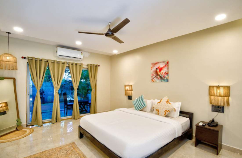 Modern bedroom with balcony and AC in Morjim luxury villa