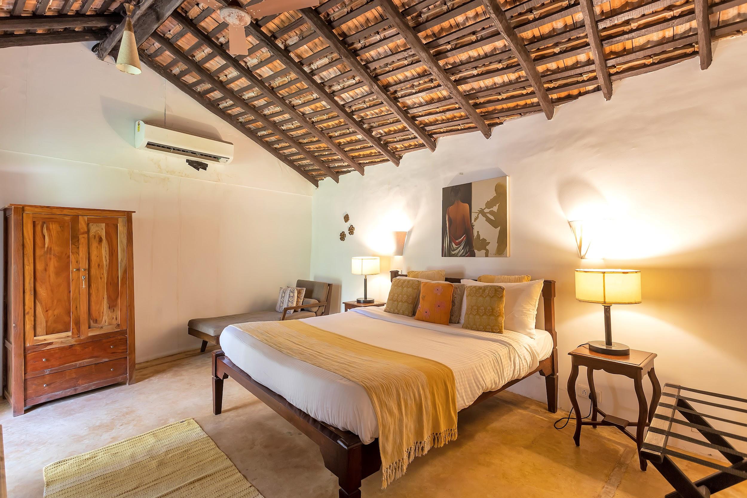 Bedroom featuring a high vaulted wooden roof, wooden wardrobe, and yellow accent throw