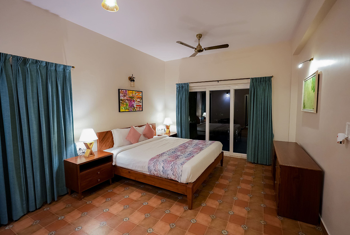 Master bedroom at night with double bed, bedside lamps, and framed art