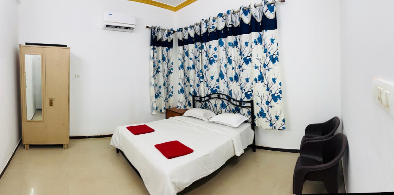 Bedroom with metal bed and wardrobe.