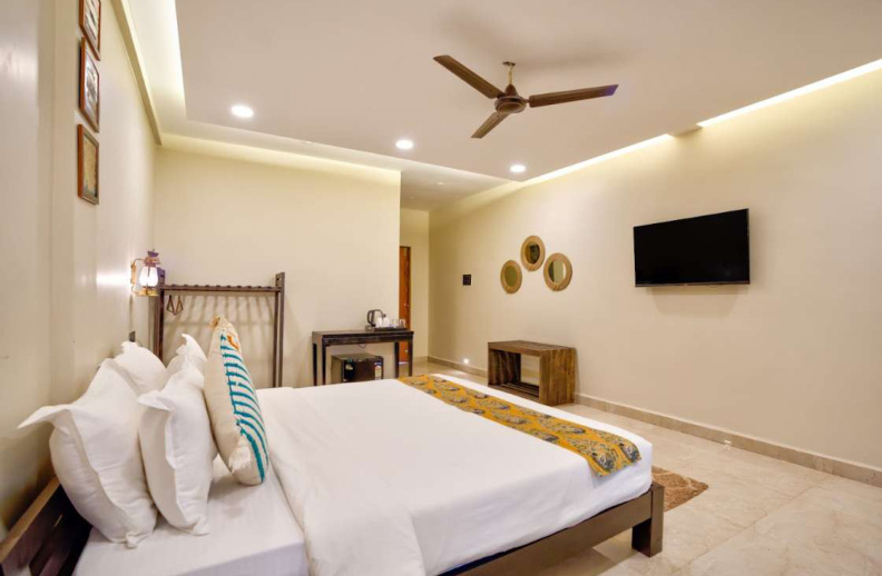 Luxury bedroom with wall mounted TV and seating space