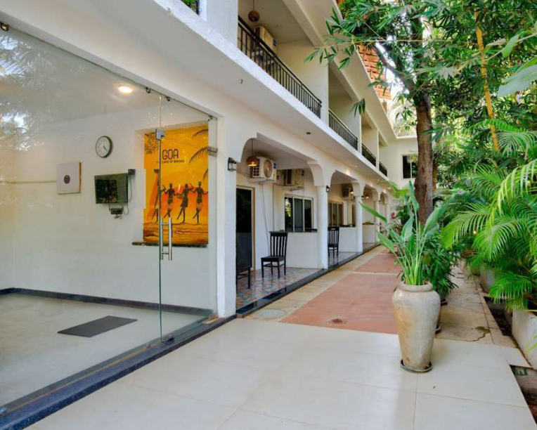 Tropical villa courtyard corridor with plants and room entrances