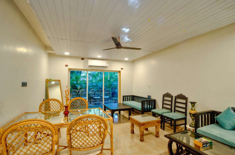 Villa living and dining area with large glass doors and garden view