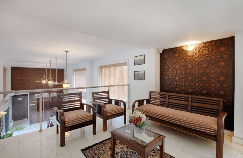 Villa lounge with wooden sofa, armchairs and coffee table