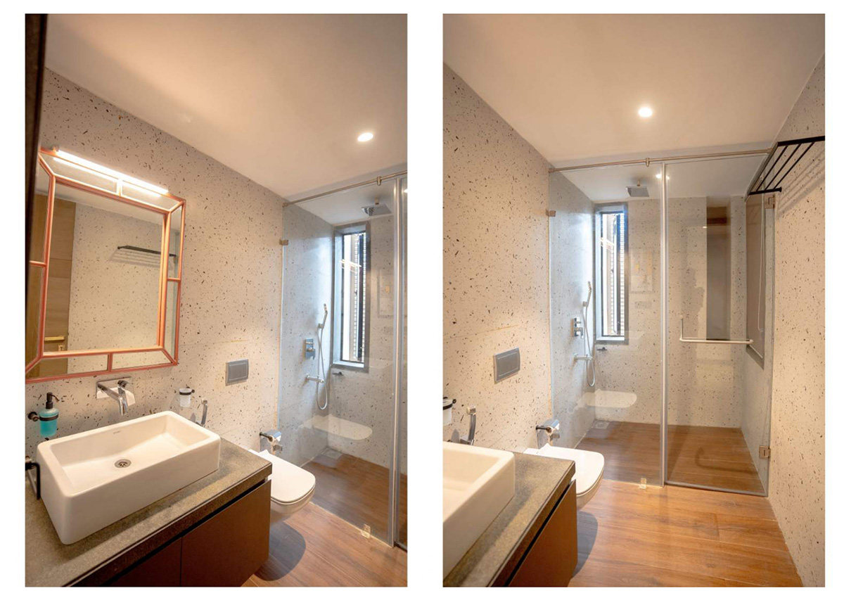 Modern villa bathroom with sleek vanity, wall-mounted basin, and glass shower enclosure