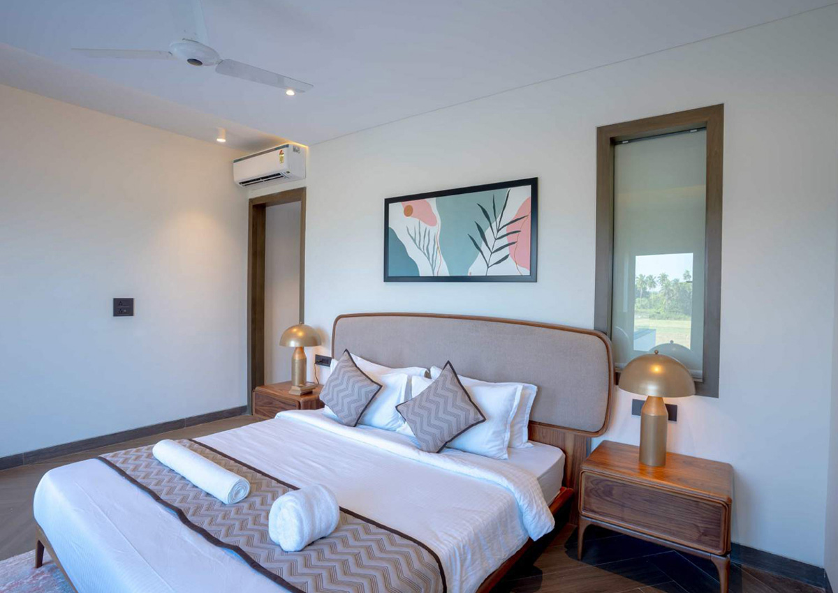 Beige-theme bedroom with picture window framing serene paddy field scenery