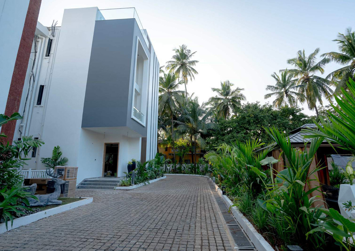 Villa driveway with landscaped greenery leading to main entrance